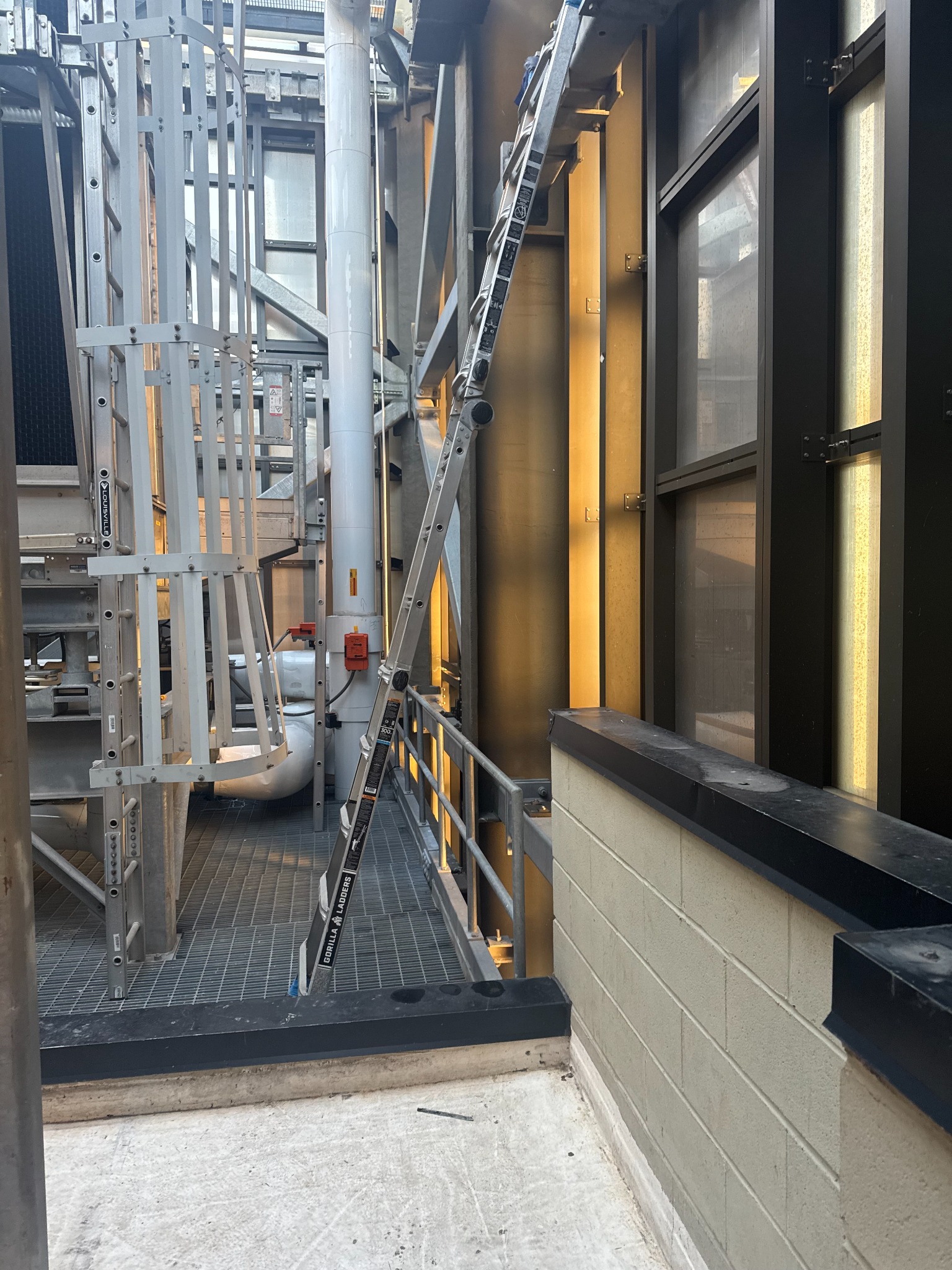 Building access area with service ladders and mechanical equipment